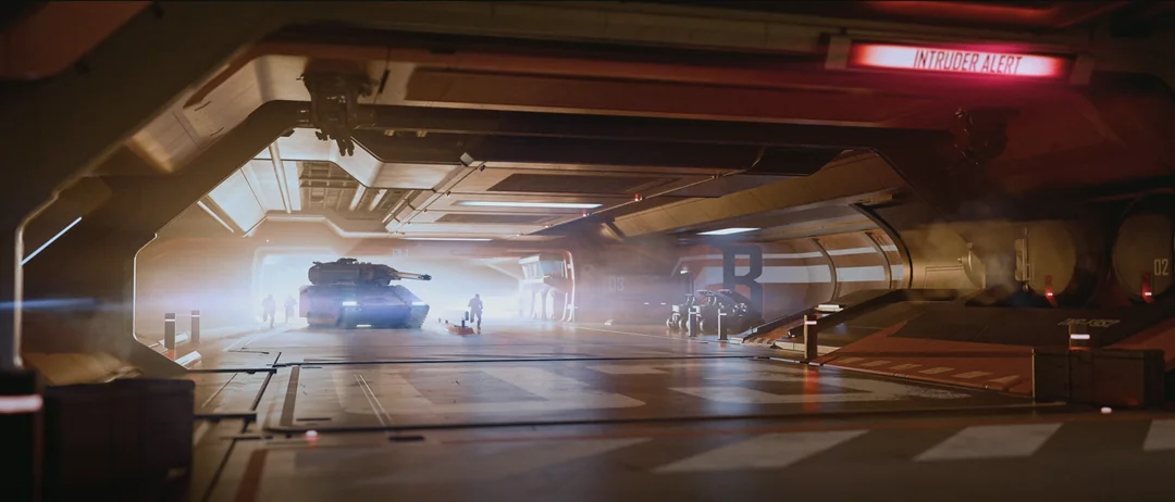 A tank and infantry advancing through a station corridor under an intruder alert.